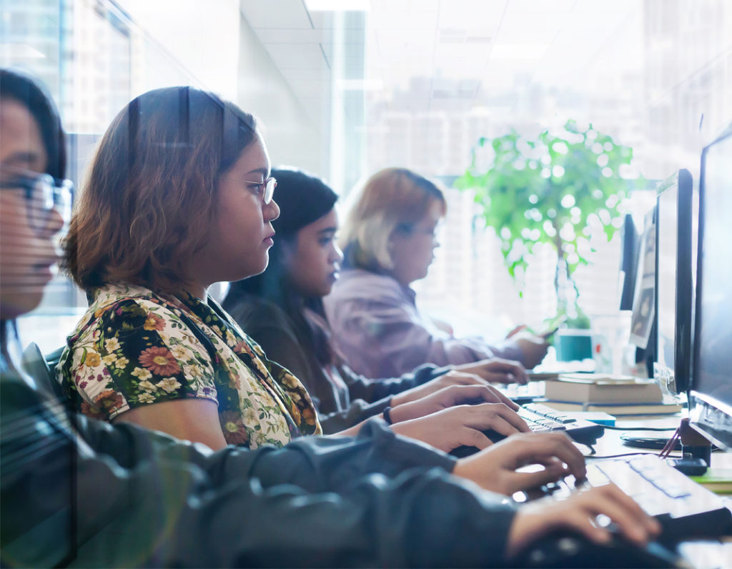 Data entry specialists at their workstations typing