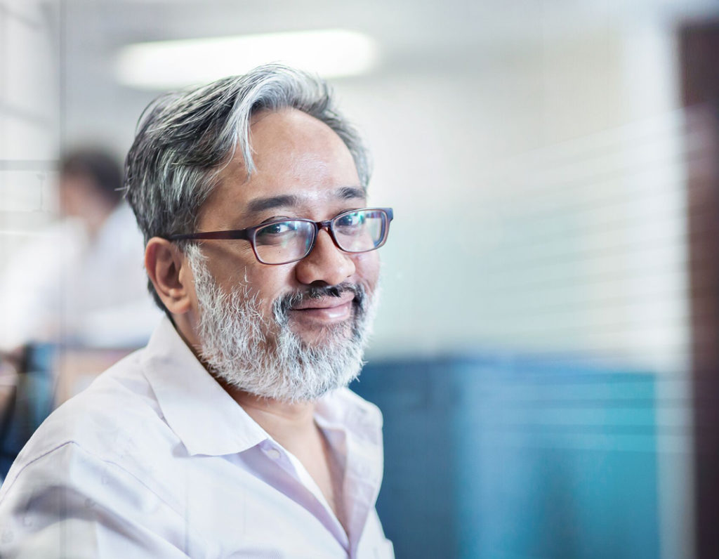 Male digital marketer with glasses smiling