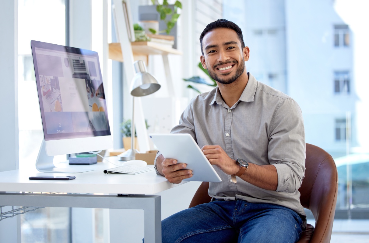 Businessman, tablet and research with portrait in the office for online work at a company. Professional male, planning and device in a workplace with leadership with ideas on the internet with smile
