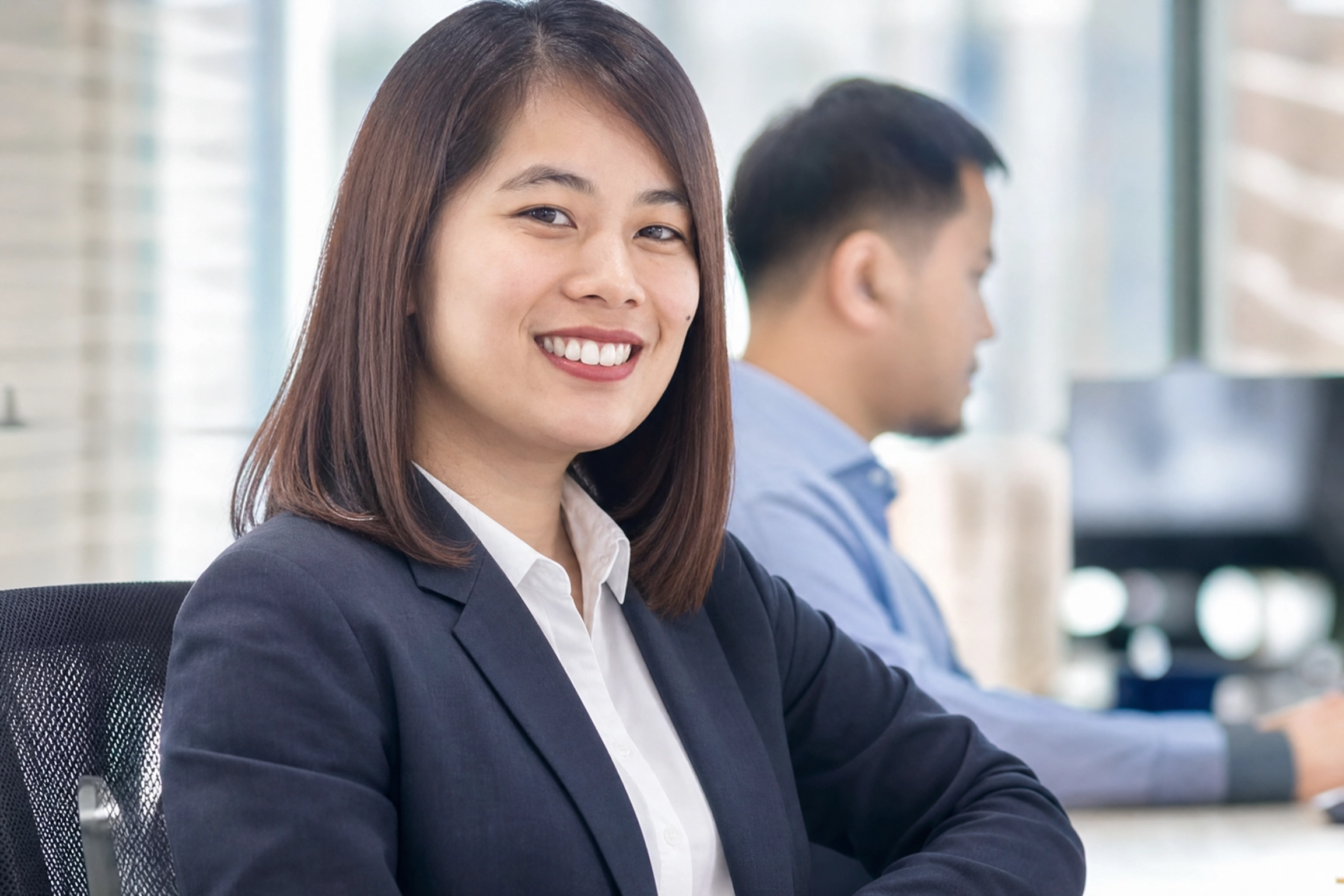 Filipina corporate worker smiling at the camera