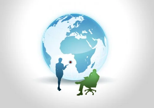 Businesswoman pointing at a location on the globe with a man sitting on an office chair