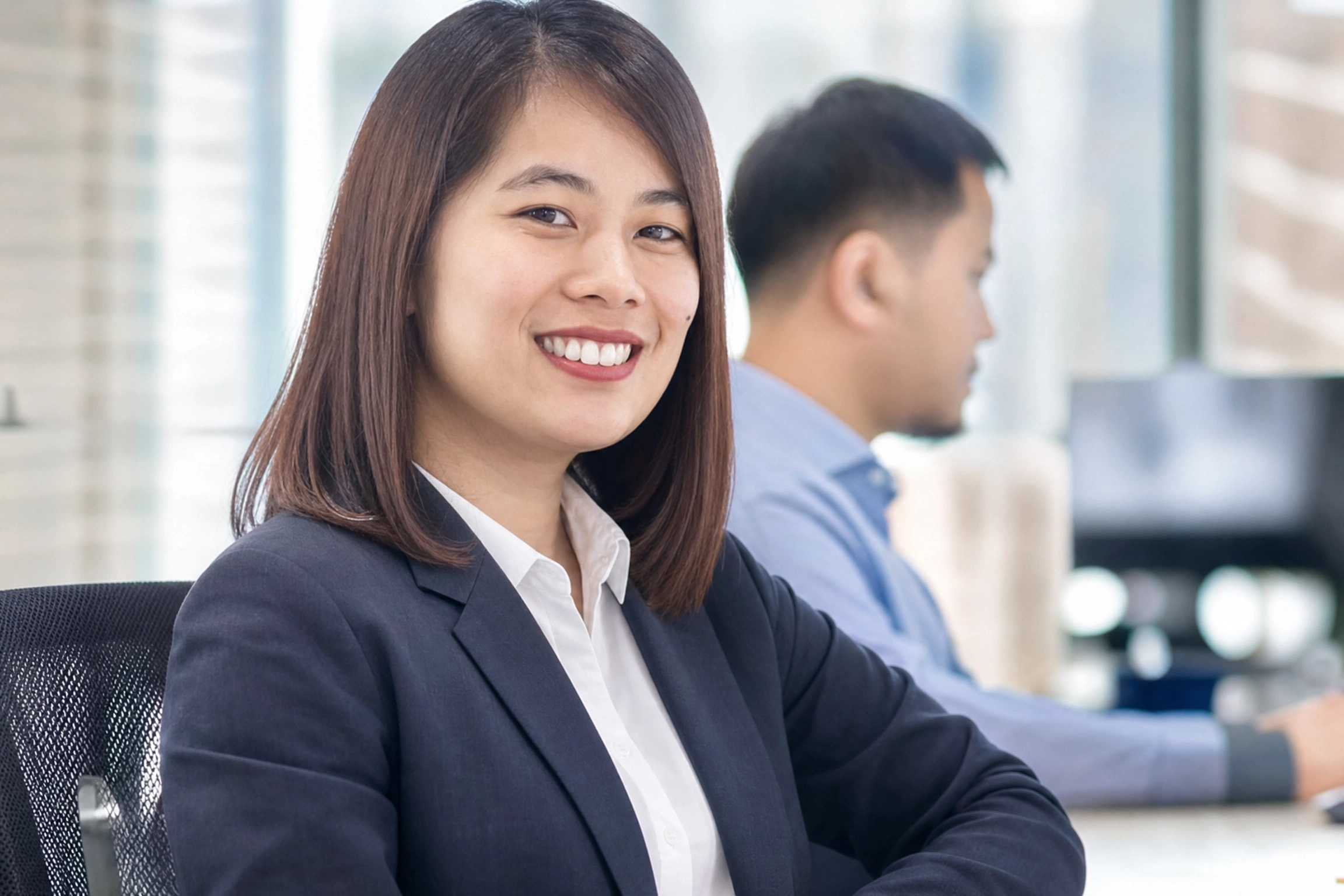 Filipina corporate worker smiling at the camera